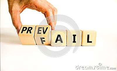 Prevail or fail symbol. Concept words Prevail or Fail on wooden cubes. Businessman hand. Beautiful white table white background. Stock Photo