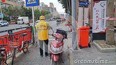 Shenzhen, China: prevent and combat the new coronavirus pneumonia on the streets, delivery couriers and some citizens Editorial Stock Photo