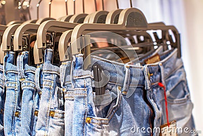 Preview jeans hanging on a hanger in the store Stock Photo