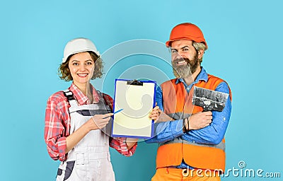 Price list. Couple look documents. Couple planning changes renovation apartment. Renovation concept. Woman and man Stock Photo