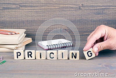 Pricing. Wooden letters on dark background Stock Photo