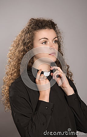 Priest adjusting her clerical collar Stock Photo