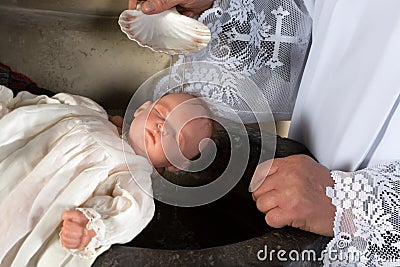 Priest baptizing baby Stock Photo