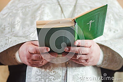Priest in church reads Stock Photo