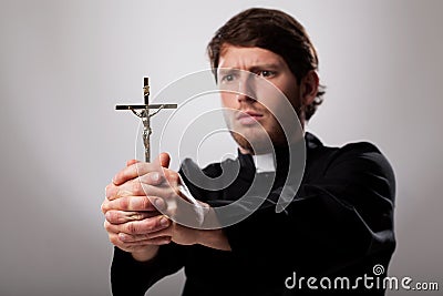 Priest with cross Stock Photo