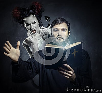 Priest evicting demons Stock Photo