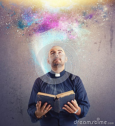 Priest observes universe light Stock Photo