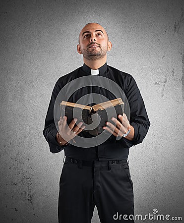 Priest praying Stock Photo