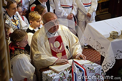 The priest preaches at the Mass on Thanksgiving day in Stitar, Croatia Editorial Stock Photo