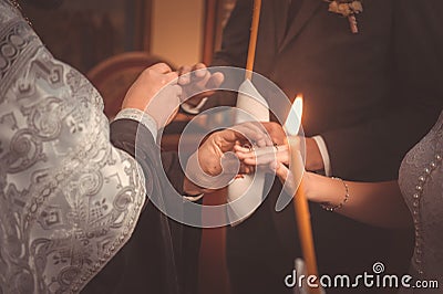 Priest putting rings during orthodox wedding ceremony Stock Photo