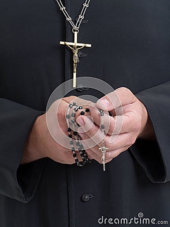 Priest with rosary Stock Photo