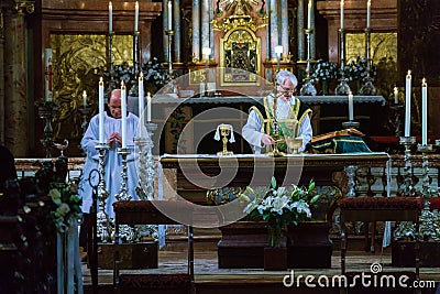 The priest serves Mass and prepares the sacrament in St. Peter`s Editorial Stock Photo