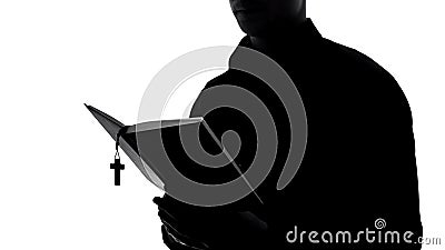 Priest silhouette reading bible, holy book preaching, religion education, faith Stock Photo