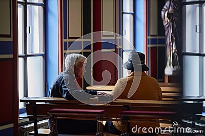 Priest talking to visitor during ministration Stock Photo