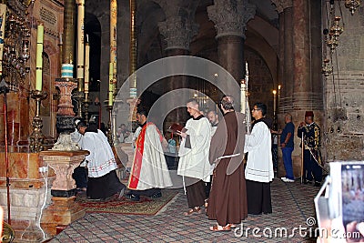 Priests at the entrance to the aedicula of the Holy Sepulchre, Jerusalem Editorial Stock Photo