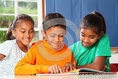 Primary school children in class reading learning Stock Photo