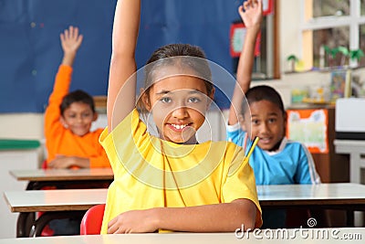 Primary school children signal with raised hands Stock Photo