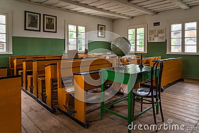 Primary school classroom with antique desks, historic building, Rumsiskes Etnographic museum Lithuania Editorial Stock Photo
