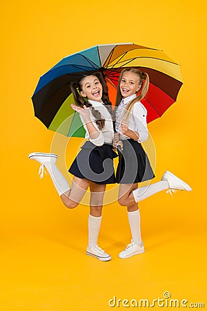 Primary school fashion. Happy school kids with fashion look holding colorful umbrella. Fashion small girls in formal Stock Photo