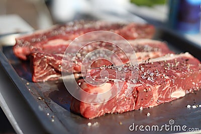 Prime steak cuts seasoned and ready for searing Stock Photo