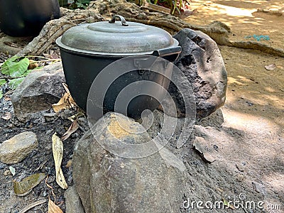 Traditional primitive Philippine style ground cooking using rocks and stones as stove Stock Photo