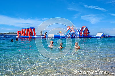 People on an inflatable water attraction. Editorial Stock Photo