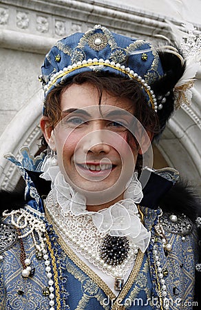 Prince Charming at the Venice Carnival. Historic building on the background. Venice, Italy Editorial Stock Photo