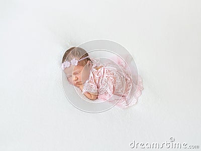 Princess baby napping in laced pink suit Stock Photo