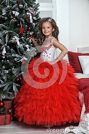 Princess in red and white dress standing near the Christmas tree Stock Photo