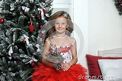 Princess in red and white dress standing near the Christmas tree Stock Photo