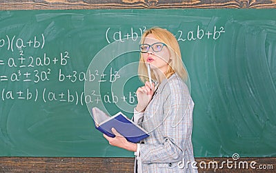 Principles can make teaching effective. Woman teaching near chalkboard in classroom. Effective teaching involve Stock Photo