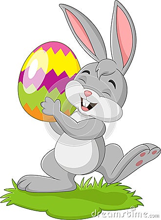 Cartoon little rabbit holding easter egg in the grass Vector Illustration