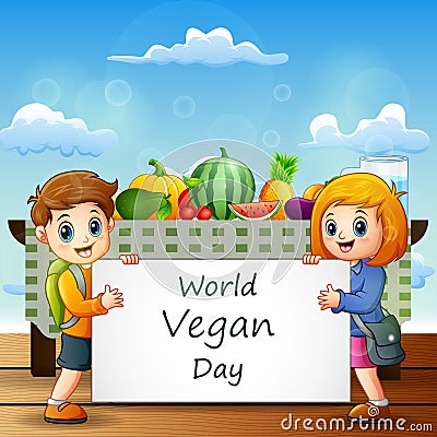 Two kids holding a sign text of World Vegan Day Stock Photo