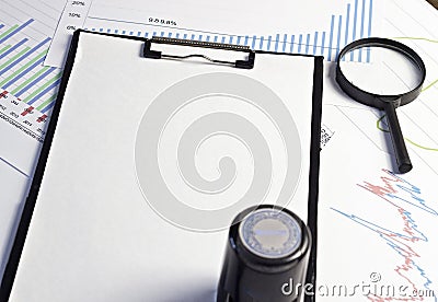 Print on a blank sheet, magnifying glass and graphics document Stock Photo