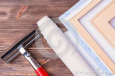Print photos on canvas. Finished paintings with a photo. tongs for stretching and a roll of canvas. Top view Stock Photo