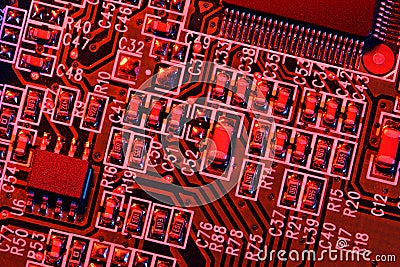 Printed circuit board and microchip, or cpu, in red light closeup - electronic component for digital equipment, concept for Stock Photo