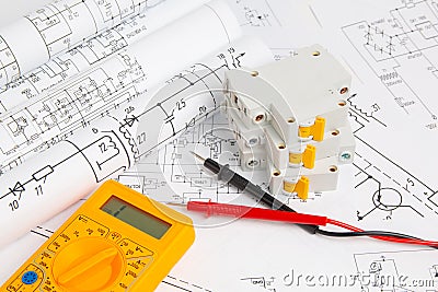 Printed drawings of electrical circuits, digital multimeter and electrical circuit breaker Stock Photo