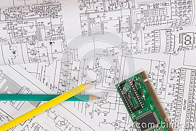 Printed drawings of electrical circuits, electronic board and pencils. Science, technology and electronics. Stock Photo