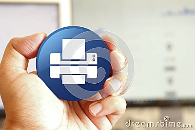 Printer icon blue round button holding by hand infront of workspace background Stock Photo