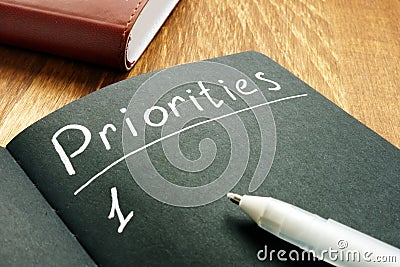 Priorities list in the black notepad Stock Photo