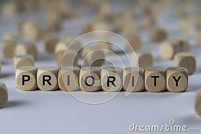 Priority - cube with letters, sign with wooden cubes Stock Photo