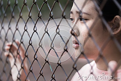 Prison asian teen behide cage Stock Photo