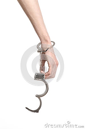 Prison and convicted topic: man hands with handcuffs isolated on white background in studio, put handcuffs on killer Stock Photo