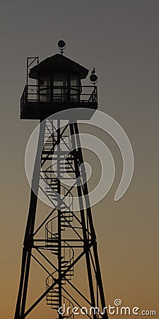 Prison guard watch tower at dusk Stock Photo