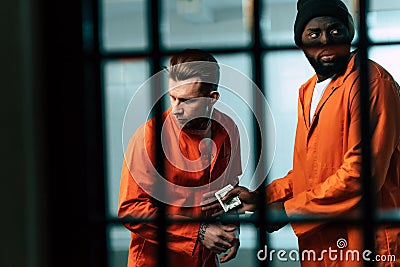 prisoner buying drugs at african american inmate Stock Photo