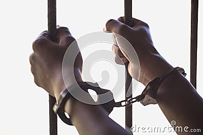 A prisoner catch a steel cage in a cell, Prisoners and police co Stock Photo