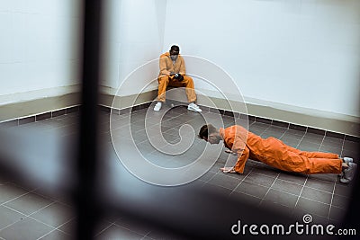 prisoner doing push-ups on floor Stock Photo