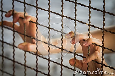 Prisoner hand in jail Stock Photo