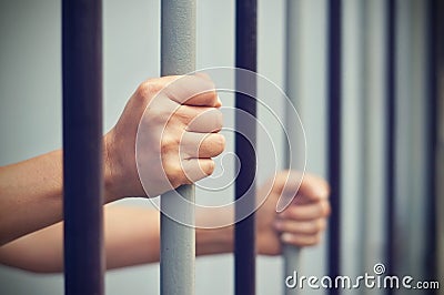 Prisoner was locked in jail, hands hold captive iron bars that i Stock Photo