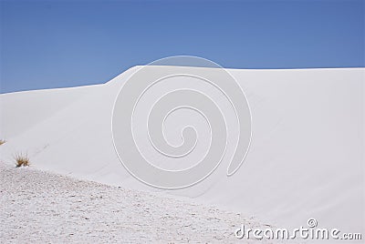 Pristine white sand dune contrasting blue sky Stock Photo